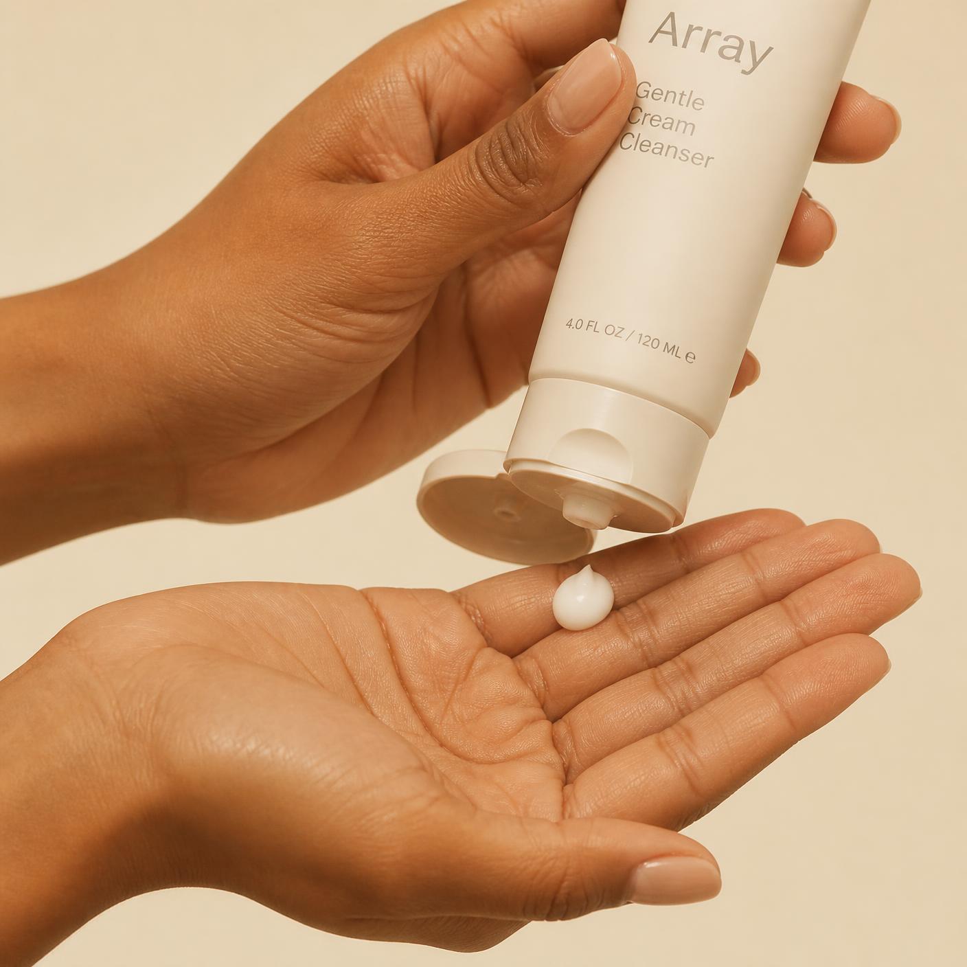 A hand dispensing cream from the Signature tube into an open palm